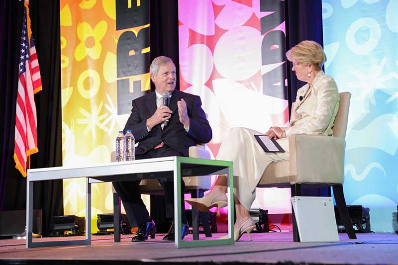 United States dept. of Agriculture Tom Bilsack with Cathy Burns from IFPA on stage at The Washington Conference.